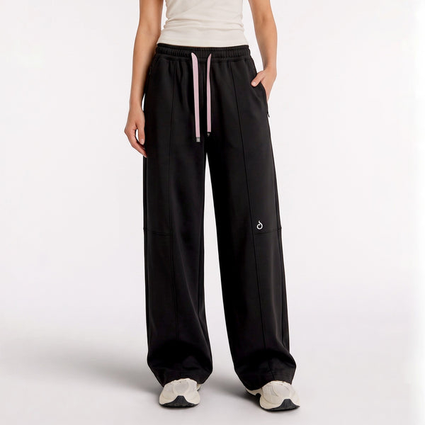 Meryia LAYN black straight-fit pants with an elastic drawstring waistband, worn by a model in a studio setting.