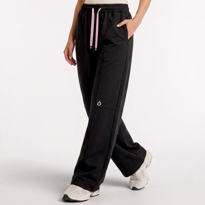 Meryia LAYN black straight-fit athletic pants with a pink drawstring and elastic waistband on a model. | Meryia مِرية