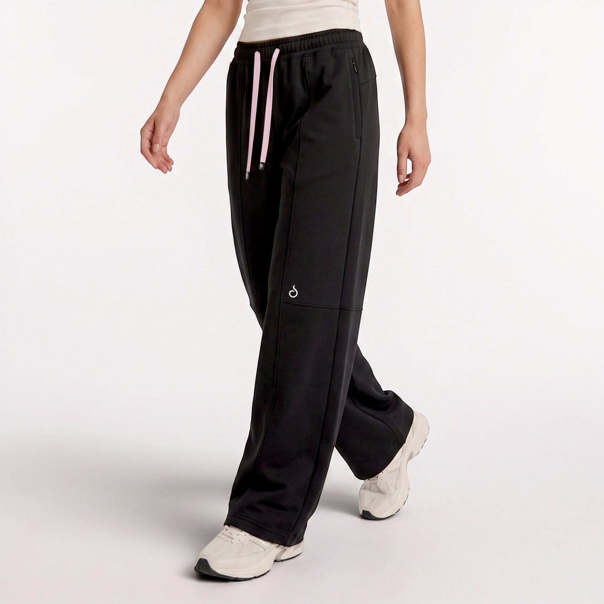 Meryia LAYN black straight-fit pants with an elastic drawstring waistband, worn by a model in a studio setting.
