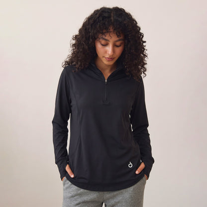 Meryia RASM black longline half-zip top with breathable fabric and seam detailing worn by a woman with curly hair | Meryia مِرية